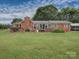 Lovely brick home boasts a spacious backyard with patio, deck, and mature landscaping at 269 Johnson Dairy Rd, Mooresville, NC 28115