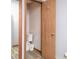 Compact bathroom featuring a toilet, wastebasket, and wooden door with convenient coat hook at 269 Johnson Dairy Rd, Mooresville, NC 28115
