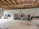 Spacious garage featuring concrete flooring, cinder block walls, and wood ceiling with exposed rafters at 269 Johnson Dairy Rd, Mooresville, NC 28115
