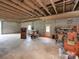 Spacious garage with exposed wooden beams, room for lawnmower, tools, and a sturdy gun safe at 269 Johnson Dairy Rd, Mooresville, NC 28115