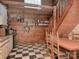 Rustic kitchen featuring checkered floors, open shelving, and a staircase enhancing its unique charm at 269 Johnson Dairy Rd, Mooresville, NC 28115