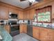 Functional kitchen with wood cabinets, stainless steel appliances, and green countertops at 269 Johnson Dairy Rd, Mooresville, NC 28115