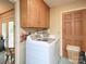 Functional laundry area featuring modern appliances and wooden cabinetry for efficient storage and organization at 269 Johnson Dairy Rd, Mooresville, NC 28115