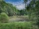 Secluded home with tranquil pond views, surrounded by lush greenery and offering a peaceful escape at 269 Johnson Dairy Rd, Mooresville, NC 28115