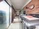Enclosed sunroom, features brick walls, and large windows providing ample light with laundry appliances at 269 Johnson Dairy Rd, Mooresville, NC 28115