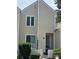 Traditional two-story townhouse featuring neutral siding, white trim, and charming picket fence at 303 Eastwood Dr, Salisbury, NC 28146