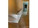 Hallway with carpeted floors leads to the laundry room on the upper level of this home at 303 Eastwood Dr, Salisbury, NC 28146