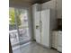 Bright kitchen featuring modern white appliances and a sliding glass door to the backyard at 303 Eastwood Dr, Salisbury, NC 28146