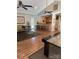 Open concept living room with wood floors, ceiling fans, and a breakfast bar into the kitchen at 303 Eastwood Dr, Salisbury, NC 28146