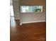 View from living area featuring hardwood floors and a pass-through window to the kitchen at 303 Eastwood Dr, Salisbury, NC 28146
