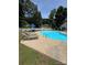 Community pool area with lounge chairs and shade umbrellas, perfect for summer days at 303 Eastwood Dr, Salisbury, NC 28146