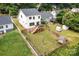 Aerial view of a fenced backyard with a playhouse and wooden deck at 304 Keswick Ave, Charlotte, NC 28206