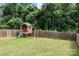 Backyard featuring a charming playhouse with slide and swing set for children at 304 Keswick Ave, Charlotte, NC 28206