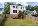 Spacious backyard with a wooden deck, lush green grass, and privacy fence at 304 Keswick Ave, Charlotte, NC 28206