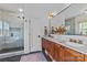 Bathroom with dual sinks, tiled shower with glass door, and modern fixtures at 304 Keswick Ave, Charlotte, NC 28206