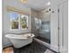 Luxurious bathroom with free-standing tub, tiled shower with glass, and modern fixtures at 304 Keswick Ave, Charlotte, NC 28206