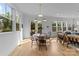 Bright dining area with modern lighting, hardwood floors, and views to the outdoor deck and backyard at 304 Keswick Ave, Charlotte, NC 28206