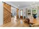 Welcoming entryway featuring beautiful hardwood floors, wooden sliding doors, and lots of natural light at 304 Keswick Ave, Charlotte, NC 28206