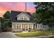 Charming two-story home with a manicured lawn, inviting front porch, and black frame windows at 304 Keswick Ave, Charlotte, NC 28206