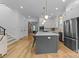 Modern kitchen featuring a large island, stainless steel appliances, and hardwood floors at 304 Keswick Ave, Charlotte, NC 28206
