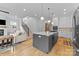 Open-concept kitchen featuring a large island, modern appliances, white cabinets, and hardwood floors at 304 Keswick Ave, Charlotte, NC 28206