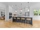 Bright kitchen with gray island, white cabinets, stainless steel appliances, and modern lighting at 304 Keswick Ave, Charlotte, NC 28206