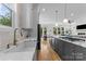 Stylish kitchen with white marble counters, island cooktop, stainless appliances, and open concept design at 304 Keswick Ave, Charlotte, NC 28206