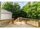 Wooden deck with stairs, surrounded by mature green trees at 312 Adams St, Salisbury, NC 28144