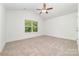 Bedroom with a ceiling fan, neutral carpet, a large window and vaulted ceiling at 312 Adams St, Salisbury, NC 28144