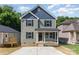 Charming two-story home with a cozy front porch and a neatly paved driveway at 312 Adams St, Salisbury, NC 28144