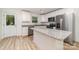 Stylish kitchen boasts granite counters, stainless steel appliances and a center island at 312 Adams St, Salisbury, NC 28144