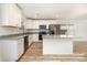Contemporary kitchen with white cabinets, granite countertops, and stainless steel appliances at 312 Adams St, Salisbury, NC 28144