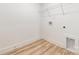 Neat and tidy laundry room featuring wood-look tile and clean white walls at 312 Adams St, Salisbury, NC 28144