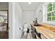 Bright bathroom features wood countertop, black fixtures, gray walls, and a modern round mirror at 327 Holly Dr, Mount Holly, NC 28120