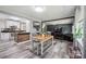 Open-concept living space seamlessly connects a dining area, kitchen, and living room at 327 Holly Dr, Mount Holly, NC 28120