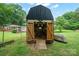 Large outbuilding with open doors, perfect for storage or workshop space in a backyard setting at 327 Holly Dr, Mount Holly, NC 28120
