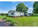 Charming home featuring a garden and a lush green backyard with a deck at 338 Hickory Grove Rd, Harmony, NC 28634