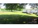 Large backyard with a well-maintained lawn and mature trees at 338 Hickory Grove Rd, Harmony, NC 28634