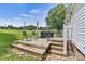 Backyard deck featuring seating, a grill, lush lawn, and a peaceful view at 338 Hickory Grove Rd, Harmony, NC 28634
