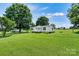 A charming home featuring a lovely front porch and lush green lawn at 338 Hickory Grove Rd, Harmony, NC 28634