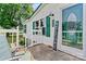 Inviting front porch with a welcome sign, green shutters, and a glass front door at 338 Hickory Grove Rd, Harmony, NC 28634