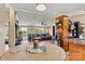 View from the dining room into the open living room, with cozy furnishings, and backyard access at 338 Hickory Grove Rd, Harmony, NC 28634