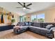 Comfortable living room with hardwood floors, a gray couch, a ceiling fan, and plenty of light at 338 Hickory Grove Rd, Harmony, NC 28634