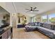 Open living space showcasing modern flooring, gray sectional, and access to outdoor views at 338 Hickory Grove Rd, Harmony, NC 28634