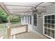 A covered porch is equipped with a fan and outdoor lighting, perfect for outdoor entertaining and relaxation at 3709 Creek Ridge Dr, Denver, NC 28037