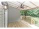A covered back porch with ceiling fan is ideal for entertaining or relaxing while enjoying the view of the fenced backyard at 3709 Creek Ridge Dr, Denver, NC 28037
