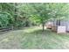An expansive backyard with mature trees and rustic fencing offers a serene outdoor retreat at 3709 Creek Ridge Dr, Denver, NC 28037