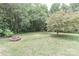 A well-maintained backyard with a charming brick fire pit, perfect for outdoor gatherings and evening relaxation at 3709 Creek Ridge Dr, Denver, NC 28037