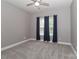 Bedroom featuring neutral walls, plush carpet, and window with dark curtains at 3709 Creek Ridge Dr, Denver, NC 28037