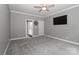 Bedroom with plush carpet, ceiling fan, and neutral paint, adjacent to a full bathroom at 3709 Creek Ridge Dr, Denver, NC 28037